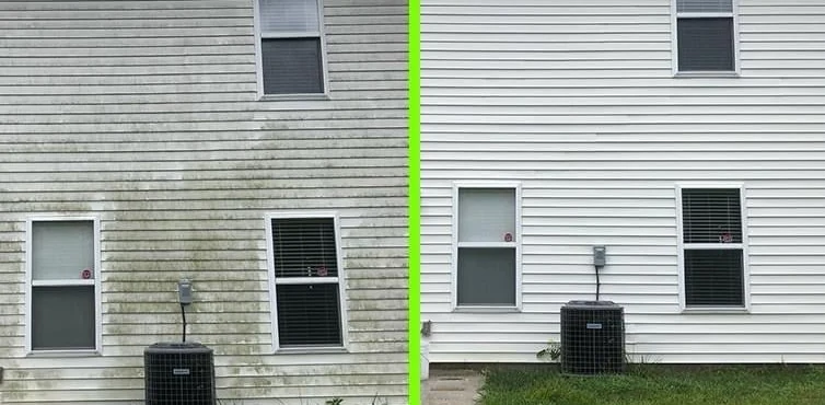A house wall, half stained and half washed